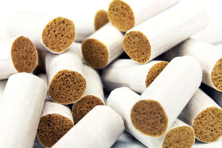 Cigarette filter tips close up white backgroundの写真素材