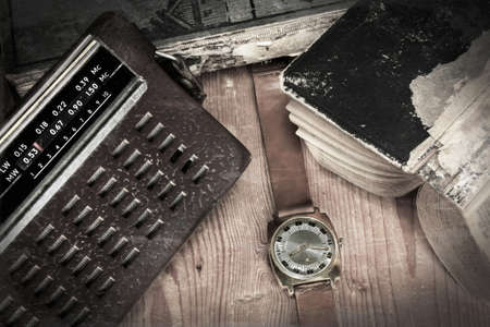 Old russian radio and watch with old books on woodenの写真素材