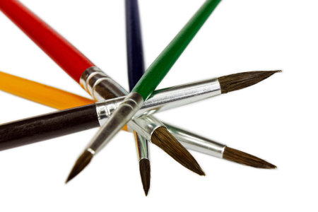 Artistic colored paint brushes isolated on white background