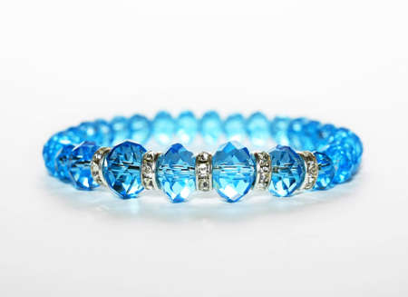 Blue bracelet isolated on white with special lightningの写真素材
