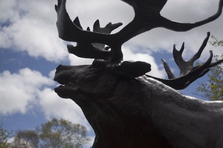 Statue of a caribou silloutted on the sky.の写真素材