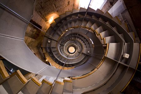 Looking up a spiral staircase in Glasgowの写真素材