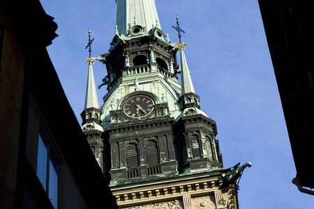 Looking up a clocktower in Gamla Stan, Stockholm.の写真素材