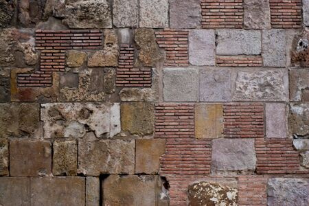 Diverse wall, build with various different stones and bricks.の写真素材