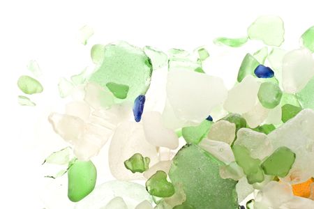 Coloured shards of glass worn by the waves on a beach. の写真素材