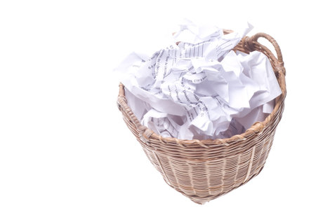 Looking at a full garbage can, filled to the brim with paper. の写真素材