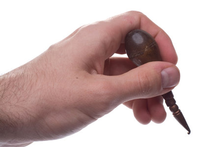 Hand holding a Rug Hook, a tool used to hook mats.の写真素材