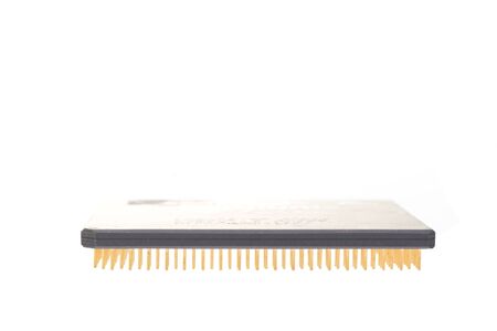 A microprocessor with gold pins isolated on a white background.の写真素材
