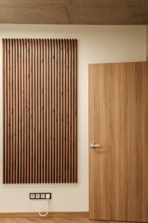 background white wall with wooden brown planks and wooden door, the socket is located at the bottom...