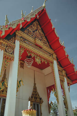 Thailand, Phuket - 2019. Wat Suwan Khiri Khet emple. Golden shutters on the windows and painted wallsのeditorial素材