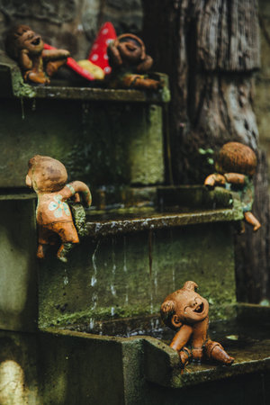 Thailand - 2019. Phuket Botanic Garden. Sculpture of children. They play with the water. Background...