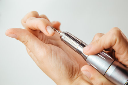 Close-up of a woman's hand holding a dental drill.の写真素材