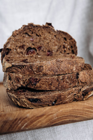 Sliced rye bread with raisins on a wooden board