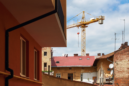 Building with crane in the old city neighbourhoodの写真素材