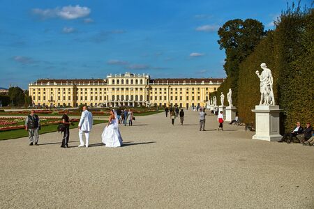 Vienna, Austria - September 24, 2014: Wedding photo shoot of bride and groom near Schonbrunn palaceのeditorial素材