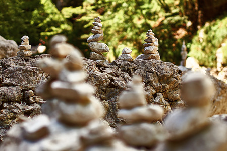 Pyramid of zen stones on the rocky mountains stream shoreの写真素材