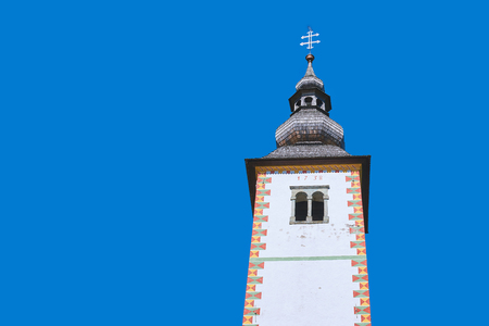 Bell tower of baroque Church of St John the Baptist in Ribcev Laz, Slovenia located on the shore of lake Bohinjの写真素材