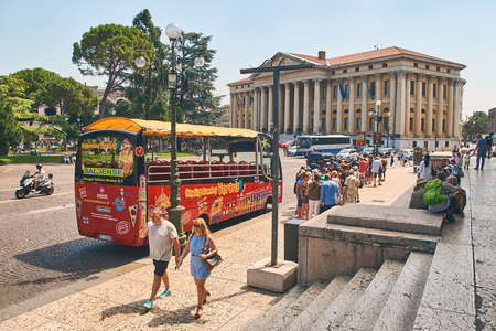 Tour bus and tourists at Piazza Bra in Verona, Italyのeditorial素材