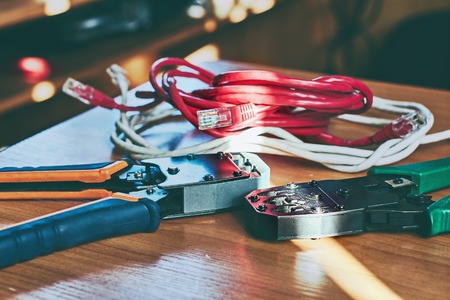 Electrical crimp tools and wire on the office table in sunlight tonedの写真素材