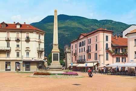 Beautiful view of Piazza Indipendenza or Independence Square in Bellinzona, Switzerland with an obelisk erected in 1803 to mark the centenary of the Act of Mediation and Sasso Corbaro castle on the hillのeditorial素材
