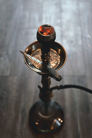 Shisha hookah bowl with craft tobacco and red hot coals and craft tobacco. Sparks from breathe....
