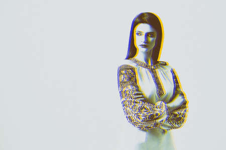 Young beautiful brunette girl wearing gorgeous ethnic style embroidered shirt, modern derivative from traditional Ukrainian vyshyvanka design. Fashion model in studio.の写真素材