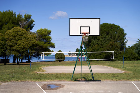 Outdoor basketball hoop or goal on blue sky background.
