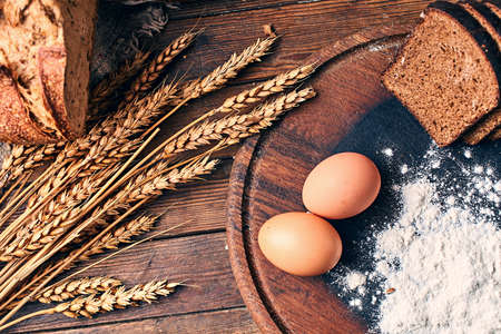 Still life with bread and its ingredients in vintage setting.の写真素材