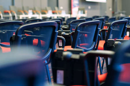 Red and black conference chairs in the auditoriumの写真素材