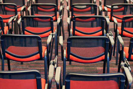 Red and black conference chairs in the auditoriumの写真素材