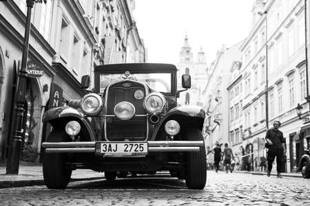 Vintage Ford car used for tourist attraction parked on the Mostecka street in historical Mala Strana district. Black and white image.のeditorial素材