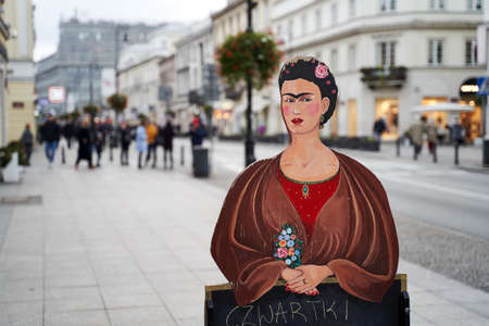 Warsaw, Poland, Nov 15, 2018: Painted plywood outdoor restaurant menu with a figure of Frida Kahlo, a famous Mexican painter, displayed on the streetのeditorial素材