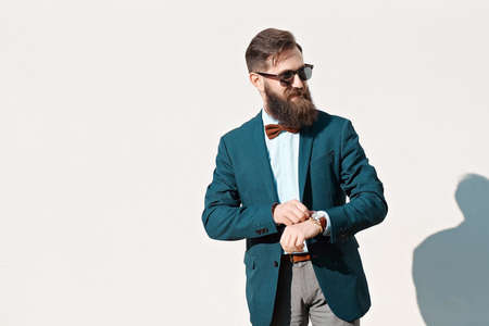 Stylish man with beard wearing a jacket, shirt and bow tieの写真素材