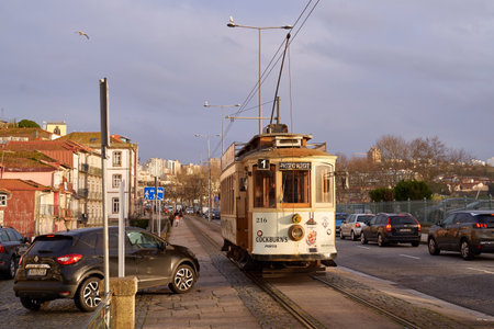 Porto, Portugal. Traditional vintage tram passes through the historical Linha 1 tram lineのeditorial素材