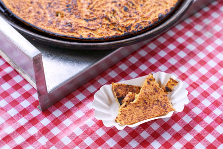 Socca, just coming out of the oven, in Nice, the French Riviera. a type of thin, Socca is a specialty of southeastern French cuisine. a pancake made from chickpea flour.の写真素材