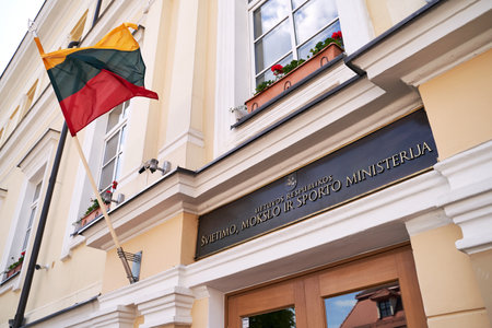 Lithuanian flag waving on the facade of the Ministry of Education, Science and Sport buildingのeditorial素材