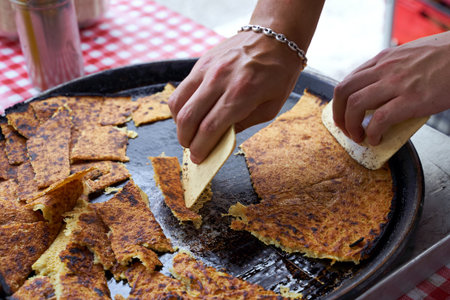 Socca, just coming out of the oven, in Nice, the French Riviera. a type of thin, Socca is a specialty of southeastern French cuisine. a pancake made from chickpea flour.の写真素材