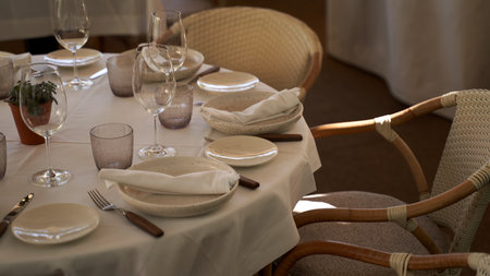 Cozy Spanish outdoor restaurant. Beautiful served table and wicker chairs on a sunny evening in Iberian style.の写真素材