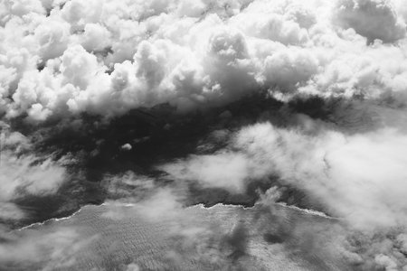 Cloudy coast. Aerial view of a dramatic beautiful ocean coastline in black and white