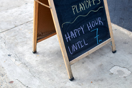 Happy hour advertisement written with chalk in New York Cityの写真素材