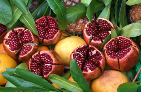 Juicy ripe pomegranates on the foliage. Sold in the outdoor marketの写真素材