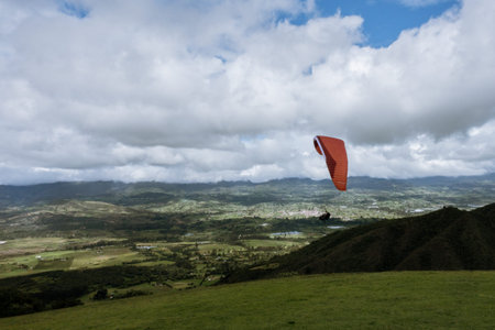 Paraglider tandem fly with blue sky, tandem paragliding over the mountains in a cloudy day