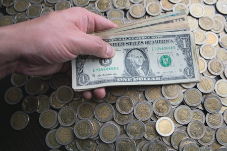 Open savings over a wooden table for financial crisis with Colombian coinsの写真素材