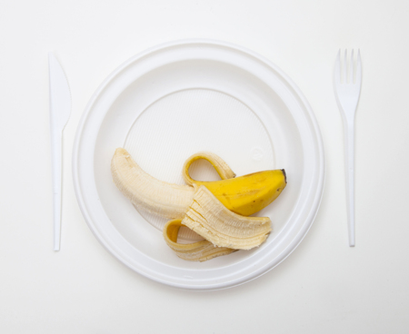 White disposable dishware set Fork, Knife and Bananaの写真素材