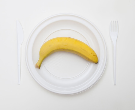 White disposable dishware set Fork, Knife and Bananaの写真素材