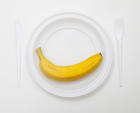 White disposable dishware set Fork, Knife and Bananaの写真素材