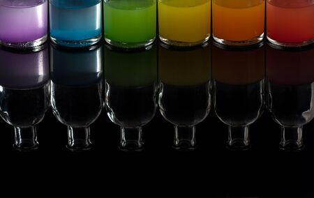 Apothecary, laboratory bottles with colored liquid with reflectionの写真素材