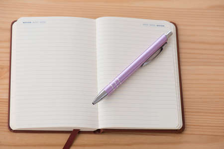 Empty calendar with a pen lying on a tableの写真素材