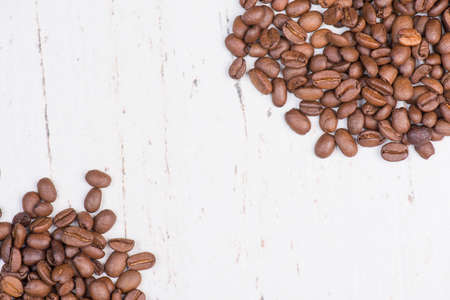 Coffee beans on a white shabby background, empty copy spaceの写真素材