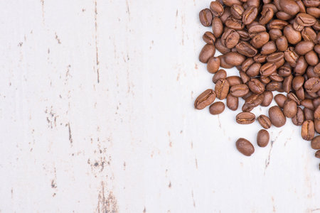 Coffee beans on a white textured background, empty copy spaceの写真素材